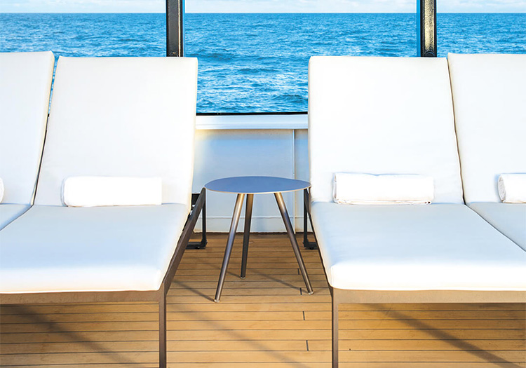 Lounge chairs on deck of Atlas Ocean Voyages cruise ship