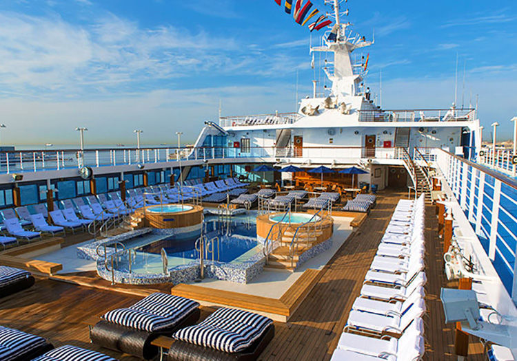 Top deck with pool, hot tub, and lounge chairs