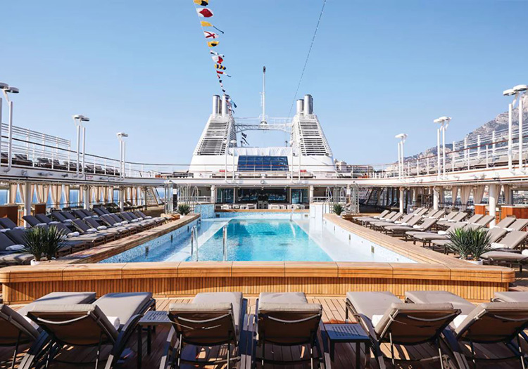 Pool deck with lounge chairs and nautical flags