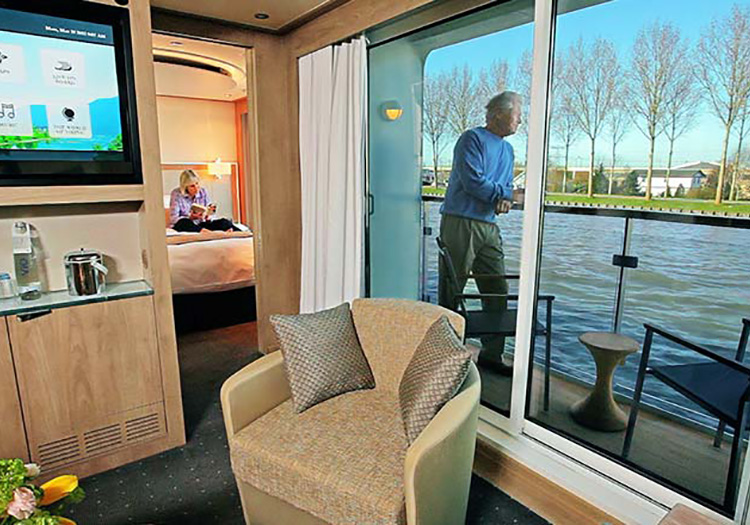Couple relaxing in their luxury stateroom